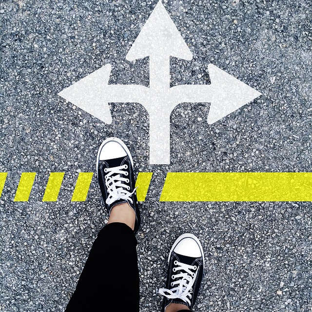 choose-the-right-direction Shoes on pavement approach arrows pointing in different directions, representing how to find a good family lawyer in Phoenix.